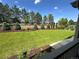 Lush backyard features a green lawn, a garden bed along the fence, and various trees for privacy at 15919 Xanthia Way, Thornton, CO 80602