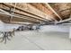 Unfinished basement with exposed ceiling, painted floors, and white walls. Ready to be customized at 15919 Xanthia Way, Thornton, CO 80602