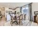 Inviting dining area open to the kitchen and living room, with a blend of modern and traditional decor at 15919 Xanthia Way, Thornton, CO 80602