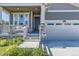 Charming front porch with beautiful stone details leads to the home's entrance and the two-car garage at 15919 Xanthia Way, Thornton, CO 80602