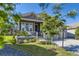 Inviting home featuring a charming front porch, manicured lawn, and professional landscaping at 15919 Xanthia Way, Thornton, CO 80602