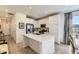 Bright kitchen with stainless steel appliances, white cabinets, and island with sink at 15919 Xanthia Way, Thornton, CO 80602