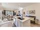 Kitchen island sink with view into dining room at 15919 Xanthia Way, Thornton, CO 80602