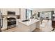 Modern kitchen with stainless steel appliances, white cabinetry, and an adjacent dining area at 15919 Xanthia Way, Thornton, CO 80602