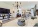 Bright living space featuring wood floors, an elegant chandelier, and contemporary furnishings at 15919 Xanthia Way, Thornton, CO 80602