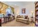 Office features desk, chair, sofa, and bookshelves at 15919 Xanthia Way, Thornton, CO 80602