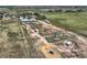 Aerial view of a large property featuring barns, paddocks, and open land at 50950 E 32Nd Ave, Bennett, CO 80102