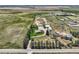 This aerial view shows a home with mature trees, outbuildings, and a long driveway for privacy and curb appeal at 50950 E 32Nd Ave, Bennett, CO 80102