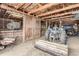 View of barn with wooden stalls, tractor, open ceilings, and concrete floor at 50950 E 32Nd Ave, Bennett, CO 80102