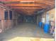 Interior view of barn with wooden stalls, concrete floor, storage and exposed ceilings at 50950 E 32Nd Ave, Bennett, CO 80102
