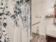 Bathroom with a shower and floral shower curtain at 50950 E 32Nd Ave, Bennett, CO 80102