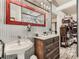 Stylish bathroom featuring silver-colored walls, a wooden vanity and rustic mirror at 50950 E 32Nd Ave, Bennett, CO 80102