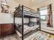 Bedroom with a bunk bed, dresser and hardwood floors at 50950 E 32Nd Ave, Bennett, CO 80102