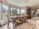 Dining area with ample windows and natural light featuring a large wooden dining table with seating at 50950 E 32Nd Ave, Bennett, CO 80102