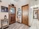 Home foyer area with decorated entry door and adjacent closet at 50950 E 32Nd Ave, Bennett, CO 80102