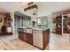 Kitchen island features a stainless steel farmhouse sink, stainless steel dishwasher and microwave and seating at 50950 E 32Nd Ave, Bennett, CO 80102