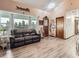 Comfortable living room with large windows, neutral walls, and a cozy leather sofa; perfect for relaxation at 50950 E 32Nd Ave, Bennett, CO 80102