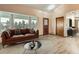 Bright living room featuring a large bay window, hardwood floors and modern furniture at 50950 E 32Nd Ave, Bennett, CO 80102