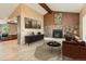 Inviting living room featuring a stone fireplace, beam ceiling, and stylish decor at 50950 E 32Nd Ave, Bennett, CO 80102
