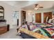 Spacious main bedroom featuring carpeted floors, ceiling fan and ensuite bathroom at 50950 E 32Nd Ave, Bennett, CO 80102