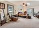 Bright main bedroom featuring a ceiling fan, window, and patio doors at 50950 E 32Nd Ave, Bennett, CO 80102