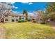 Expansive backyard featuring a lush lawn, mature trees, and an inviting patio area at 7743 S Birch Ct, Centennial, CO 80122