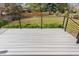 View of the backyard from a wooden deck featuring grass and metal fencing at 7743 S Birch Ct, Centennial, CO 80122