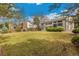Spacious backyard featuring mature trees and healthy green grass at 7743 S Birch Ct, Centennial, CO 80122