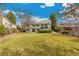 Spacious backyard showing mature shade trees and healthy green grass at 7743 S Birch Ct, Centennial, CO 80122