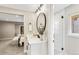 Modern bathroom with vanity, round mirror, and glass enclosed walk in shower at 7743 S Birch Ct, Centennial, CO 80122