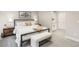 Beautiful bedroom with neutral tones, large bed, art and bench seating at 7743 S Birch Ct, Centennial, CO 80122