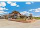 View of clubhouse and golf course featuring brick wall, rock landscaping and manicured bushes at 7743 S Birch Ct, Centennial, CO 80122