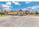 Exterior view of a community clubhouse with accessible parking and well-maintained landscaping at 7743 S Birch Ct, Centennial, CO 80122