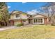 Attractive two-story home featuring a brick facade, manicured lawn, and an attached two-car garage at 7743 S Birch Ct, Centennial, CO 80122