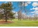 Scenic golf course showcasing lush green fairways, mature trees, and blue skies, creating a tranquil and picturesque landscape at 7743 S Birch Ct, Centennial, CO 80122
