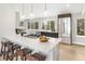 Modern kitchen with a large island, pendant lighting, and stainless steel appliances at 7743 S Birch Ct, Centennial, CO 80122