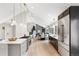 Open-concept kitchen with an island, stainless steel appliances, and access to the dining area at 7743 S Birch Ct, Centennial, CO 80122