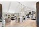 Spacious kitchen flowing to the living area with a large island and stainless appliances under a soaring ceiling at 7743 S Birch Ct, Centennial, CO 80122