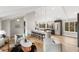 Open-concept layout with a kitchen island, living room seating, and modern lighting fixtures at 7743 S Birch Ct, Centennial, CO 80122