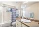 Functional bathroom with a shower-tub, neutral-colored vanity, and a decorative shower curtain at 26903 E Easter Pl, Aurora, CO 80016
