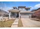 Well-maintained two-story home featuring a covered porch, gray siding, and a two-car garage at 26903 E Easter Pl, Aurora, CO 80016