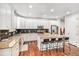 Bright kitchen features a large island, stainless appliances, granite countertops, and wooden floors at 26903 E Easter Pl, Aurora, CO 80016