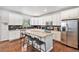 Spacious kitchen featuring stainless steel appliances, granite counters, and a large island with seating at 26903 E Easter Pl, Aurora, CO 80016