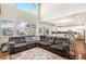 Open-concept living space featuring hardwood floors and a connected modern kitchen at 26903 E Easter Pl, Aurora, CO 80016
