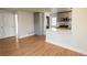 Open concept kitchen with gray cabinets, stainless steel appliances, and breakfast bar at 1564 Verbena St, Denver, CO 80220