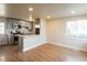 Open concept kitchen with stainless steel appliances, and island in view of living space at 1564 Verbena St, Denver, CO 80220