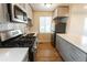 Modern kitchen featuring stainless steel appliances, gray cabinets, and a breakfast bar at 1564 Verbena St, Denver, CO 80220