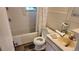 Cozy bathroom with a tub, toilet, and a small vanity, offering essential amenities at 1653 Trenton St, Denver, CO 80220