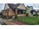 Charming two-story home featuring a classic brick facade, covered front porch, and a well-maintained lawn at 1653 Trenton St, Denver, CO 80220