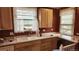 Traditional kitchen with wooden cabinets, a double sink, and ample counter space for cooking and meal preparation at 1653 Trenton St, Denver, CO 80220